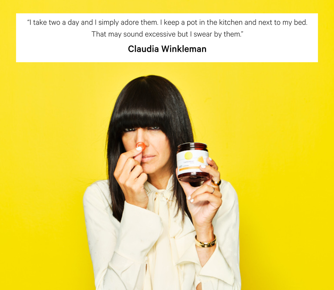 Claudia Winkleman holds up a jar of Cannaray CBD Gummies.