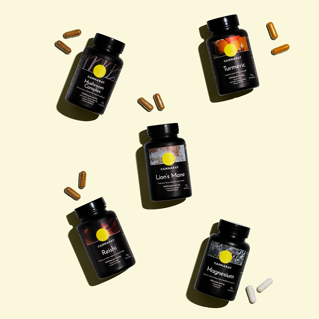 Collection of Cannaray Wellness Capsules on a pale yellow background.